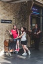 Tourists photographing at Platform 9 3/4, Kings Cross Railway Station, London